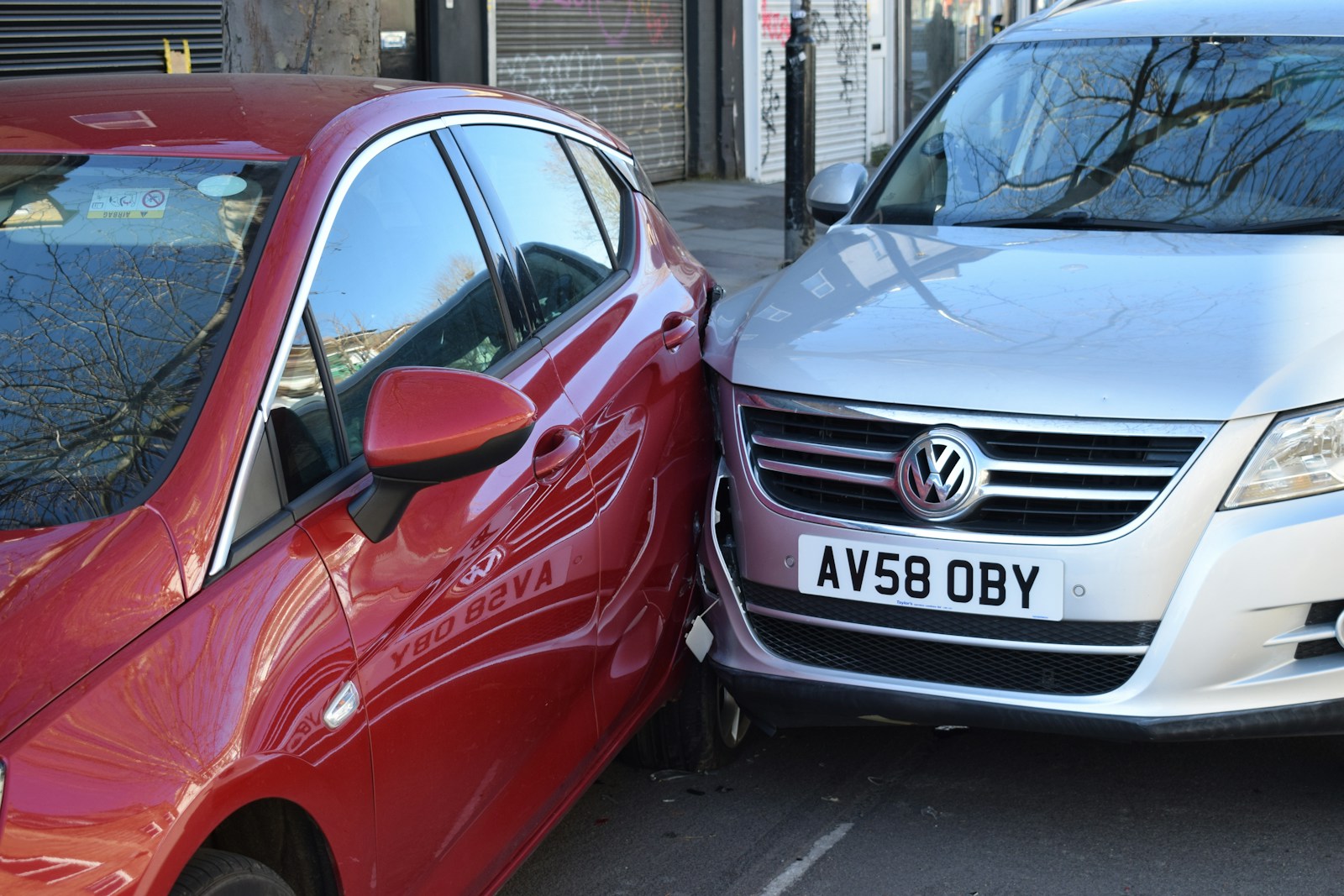 two cars parked next to each other in a parking lot, car accident uninsured